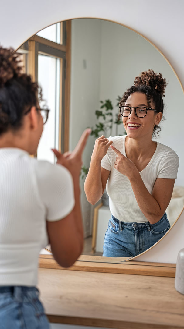 cheerful-lady-pointing-her-reflection-mirror-home